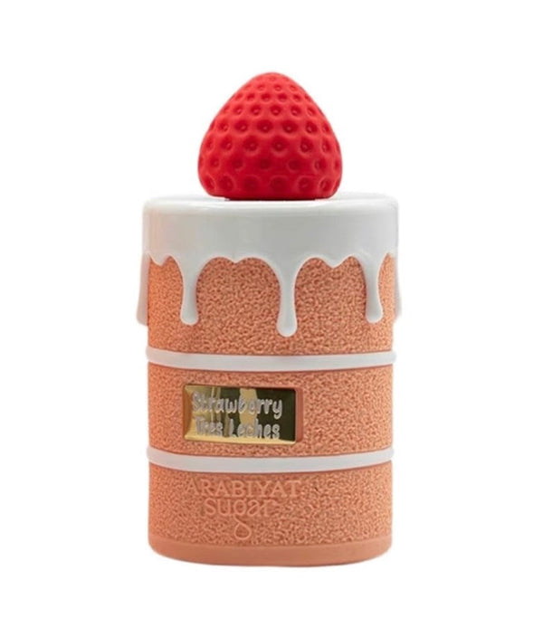 Perfume bottle with strawberry on top against a white background
