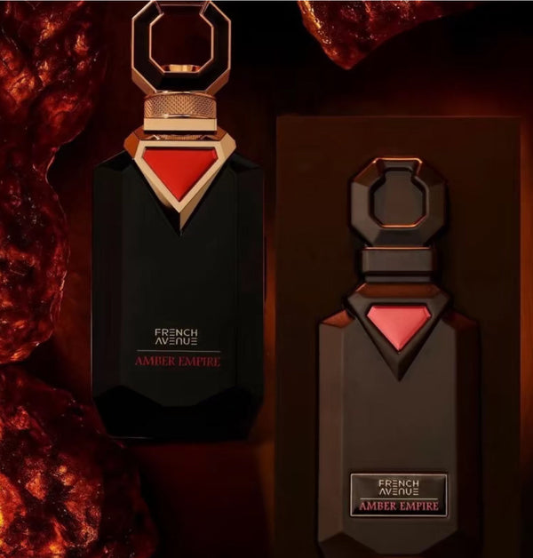 Two bottles of French Avenue Amber Empire perfume with a dark background