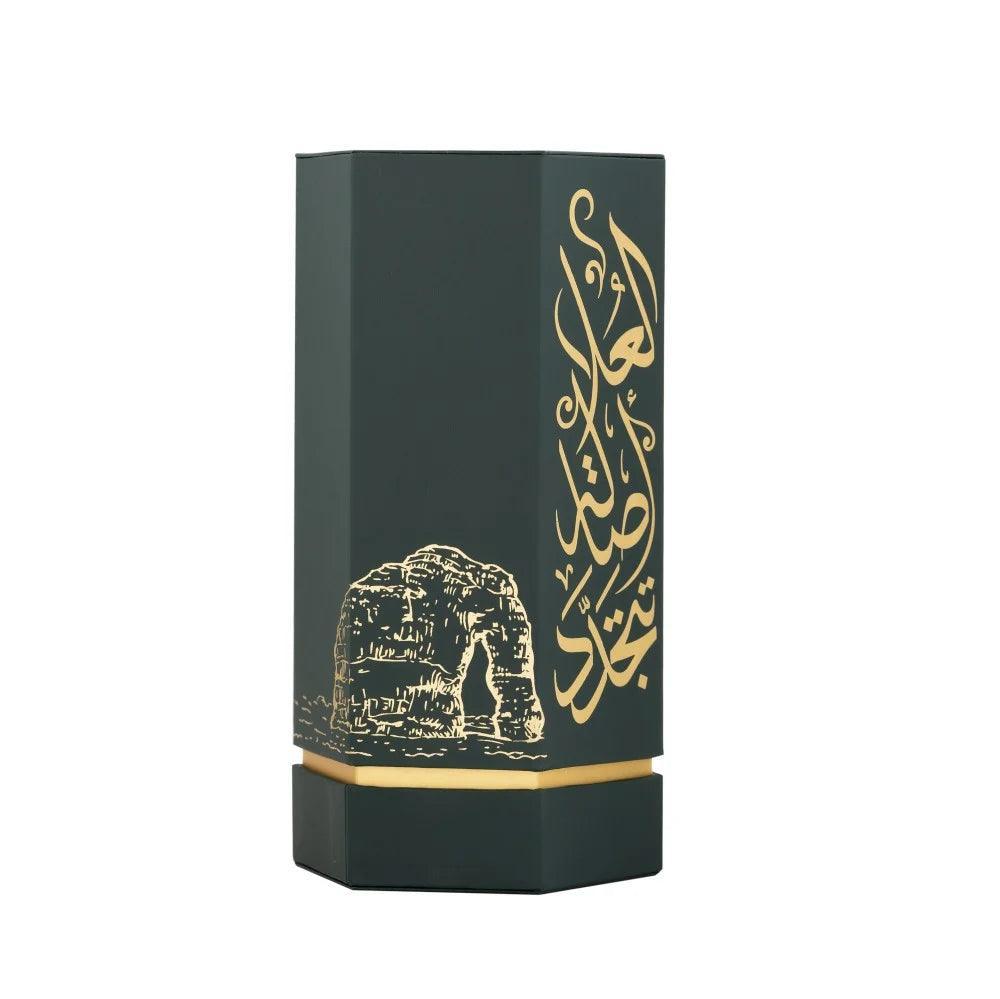 Back view of REEF Arabs of Al Ula 100ml EDP packaging featuring gold Arabic script and Al Ula rock formation illustration, in luxury perfume design.