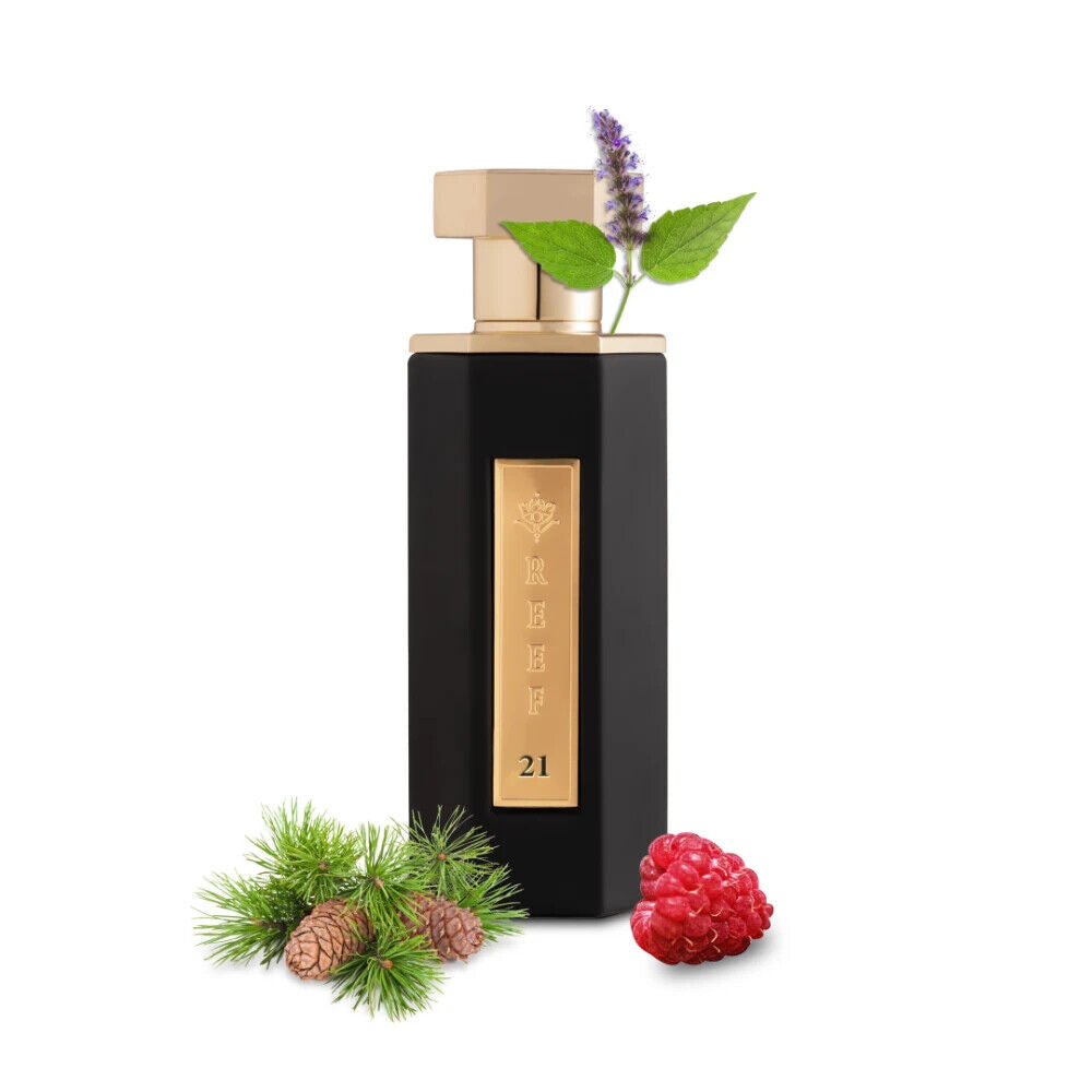 REEF 21 By Reef Perfumes EDP 100ml bottle with gold label, surrounded by raspberry, pine, and mint notes, highlighting its bold, woody scent.