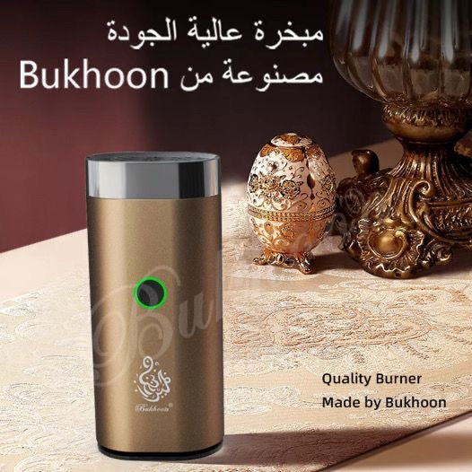 Gold Portable Electric Rechargeable Bakhoor Burner displayed on ornate table, highlighting elegant home fragrance accessory by Bukhoon.