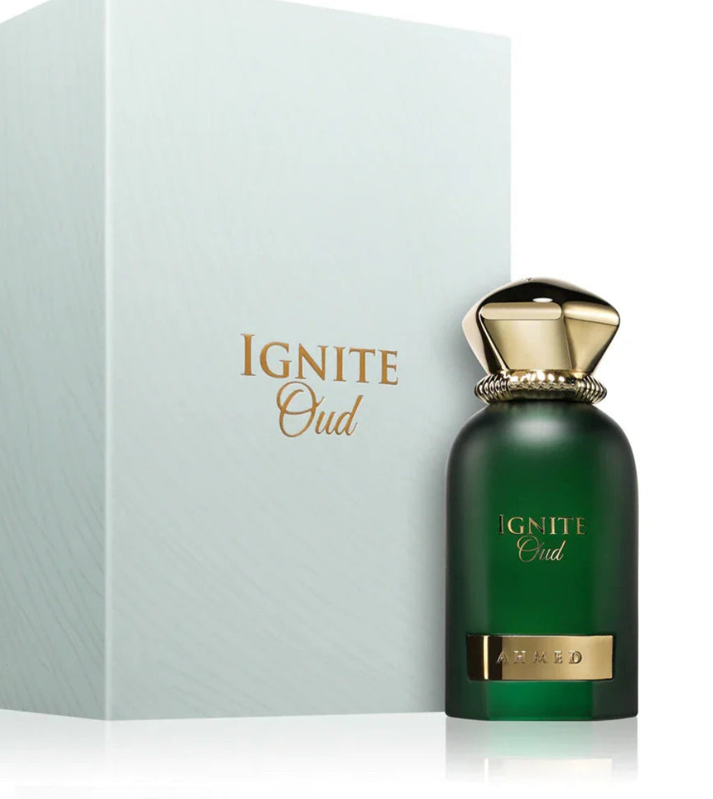 Green perfume bottle with gold cap and 'Ignite Oud' text on a light gray background