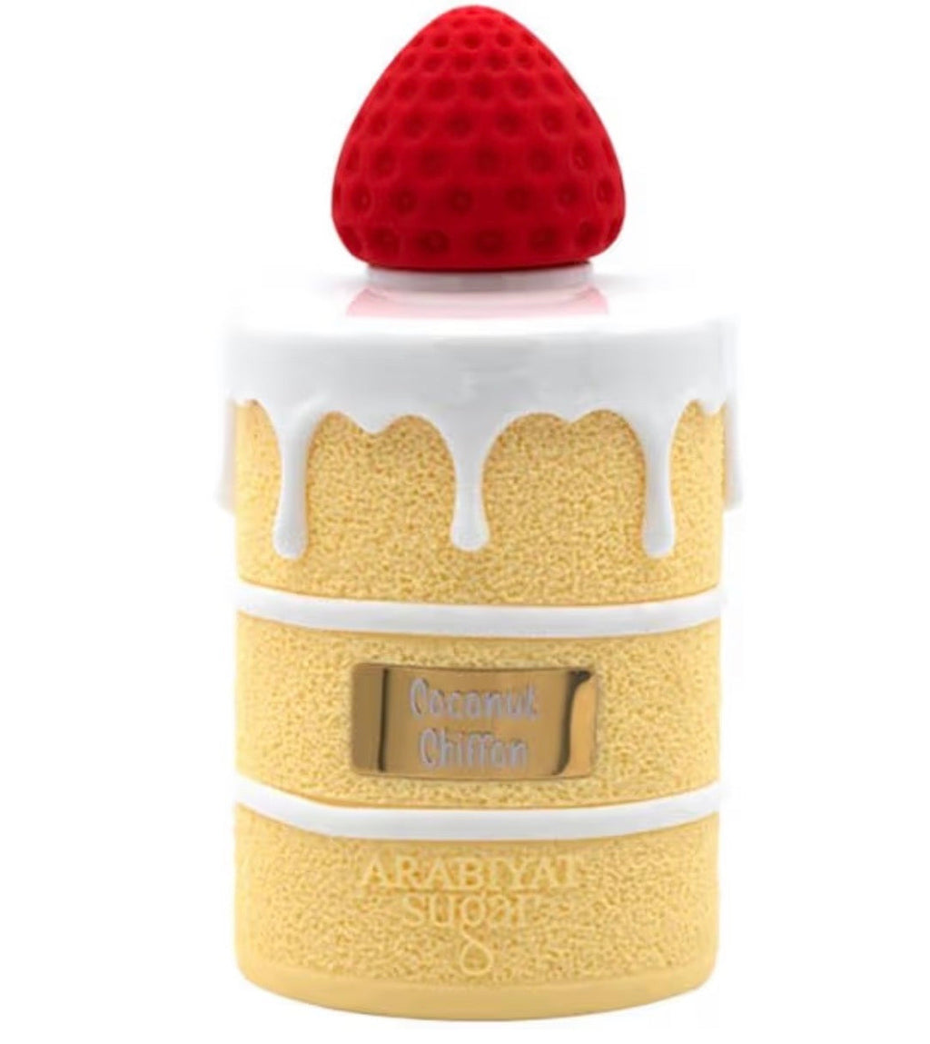 Perfume bottle shaped like a cake with a red cap on a white background