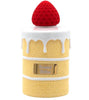 Perfume bottle shaped like a cake with a red cap on a white background