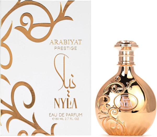 Nyla by Arabiyat Prestige 80ml EDP for women with floral fruity notes, shown with elegant gold bottle and matching white-gold packaging box.