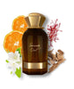 Brown perfume bottle with gold cap surrounded by orange slices, flowers, and spices on a white background