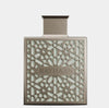 Perfume bottle with intricate design and 'RAYHAAN' branding on a light gray background