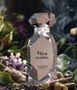 Marwa Arabiyat Prestige perfume bottle with smoke and flowers in the background