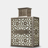 Decorative lantern with intricate cut-out design on a light gray background
