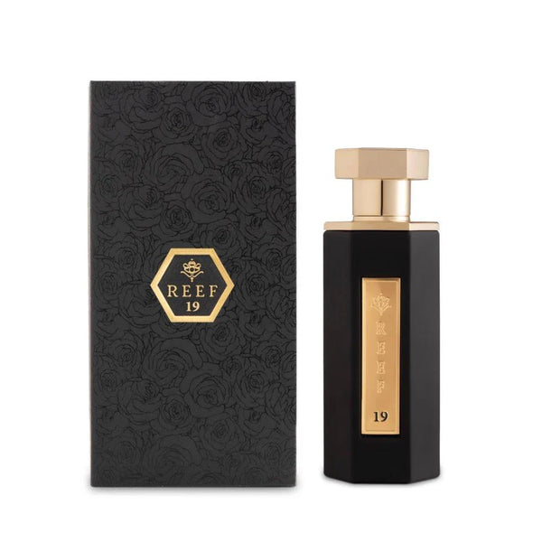 REEF 19 By Reef Perfumes EDP 100ml in a sleek black and gold bottle with matching floral-embossed packaging, ideal for unisex fragrance lovers.