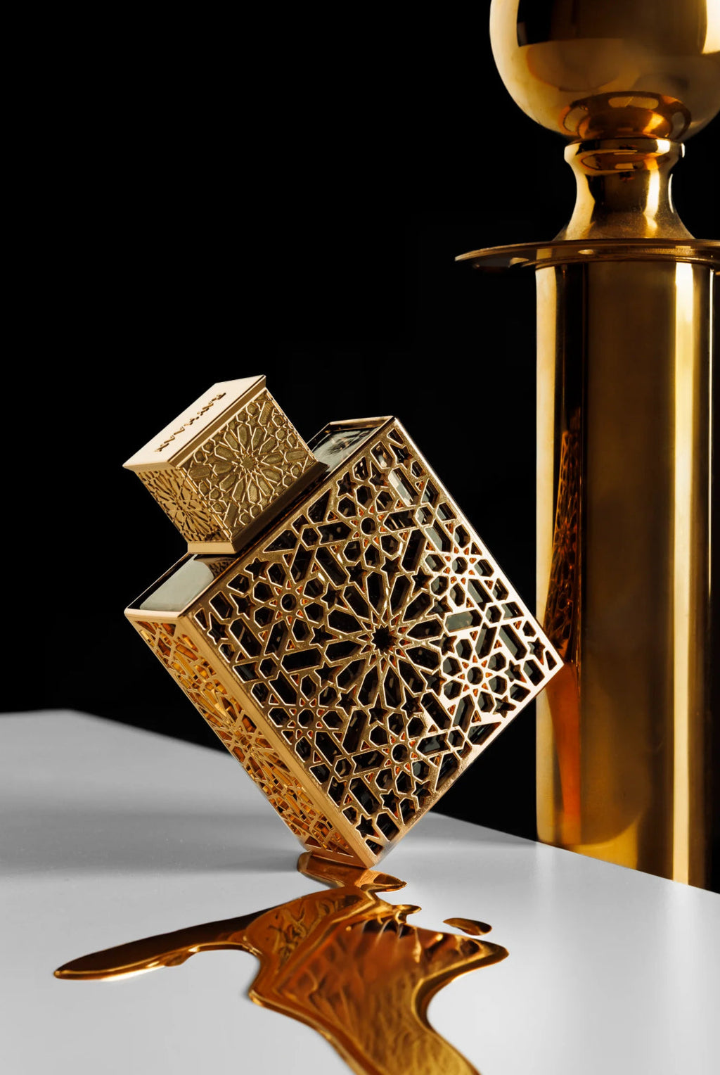 Decorative gold object with intricate patterns on a reflective surface