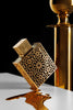 Decorative gold object with intricate patterns on a reflective surface