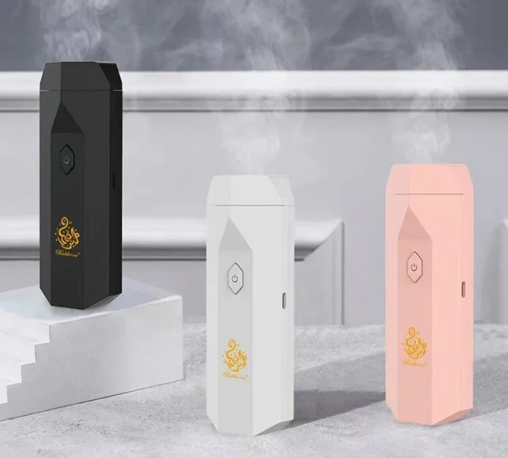 Electric Portable Bakhoor Incense Burner combs in black, white, and pink emitting smoke, perfect for aromatherapy in Health & Beauty category.