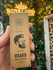 Hand holding a cardboard box labeled 'Beard Grooming Oil' with a blurred background