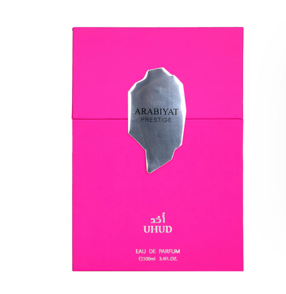Pink perfume box with silver logo and text on a white background