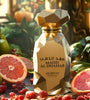 Gold perfume bottle labeled 'MAHD AL DHAHAB' surrounded by fruits on a wooden surface.