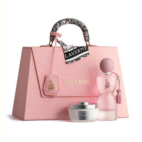 Pink handbag with 'Laverne' branding, featuring a pink perfume bottle and white jar on a light pink background.