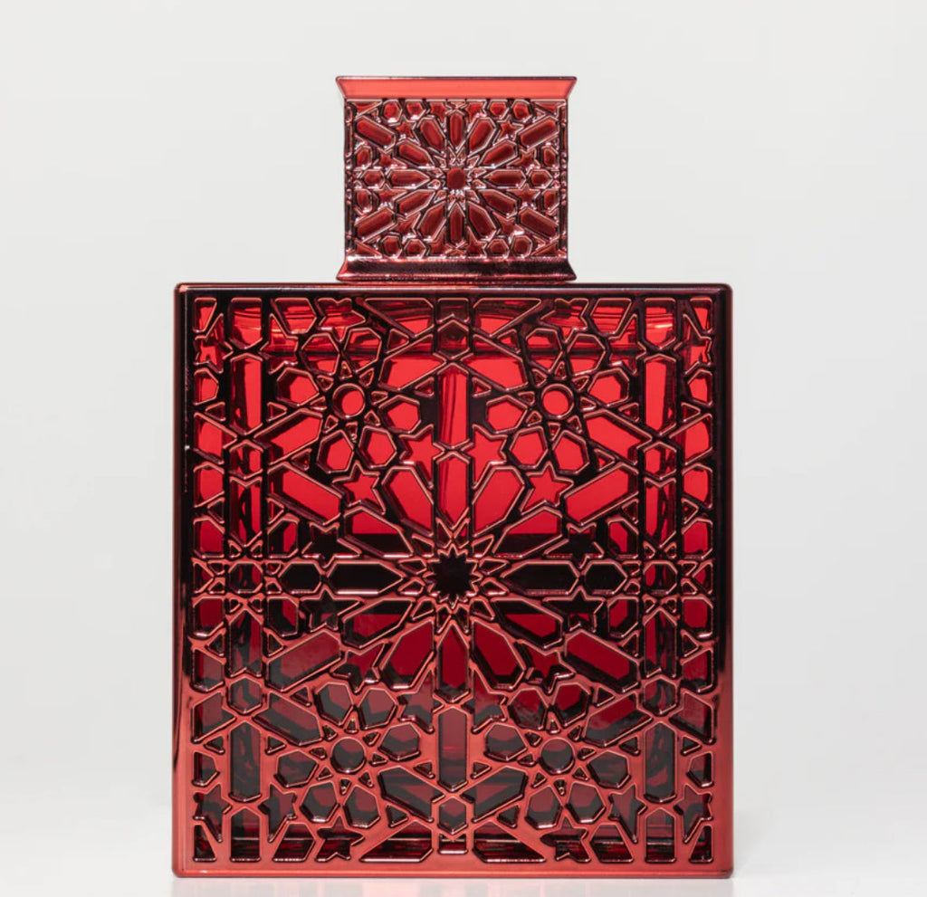 Decorative red metal box with intricate geometric pattern on a white background