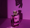 Purple perfume bottle with decorative cap on a purple background