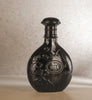 Elegant black Nyla Suede perfume bottle by Arabiyat Prestige featuring embossed floral design, perfect for warm, musky, and sweet unisex fragrance lovers.
