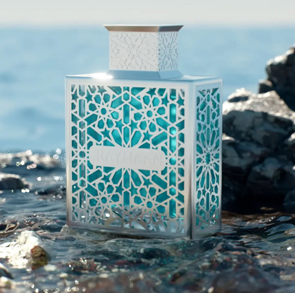 Decorative bottle with geometric pattern on a rocky beach