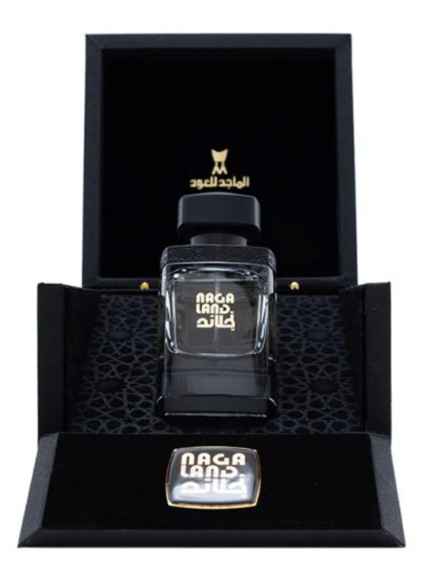 Nagaland Perfume -50 Ml by Al Majed Oud displayed in a luxurious black gift box with gold accents and intricate interior design.