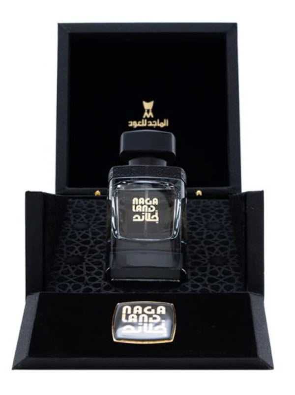 Nagaland Perfume -50 Ml by Al Majed Oud displayed in a luxurious black gift box with gold accents and intricate interior design.
