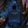 Perfume bottle labeled 'Nocturno' by Rayhaan on a natural background with water and wood.