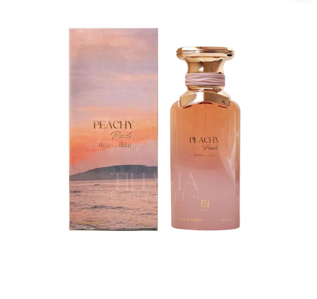 Perfume bottle and packaging with peachy design on a white background