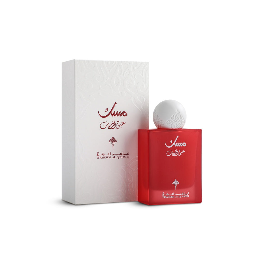 Red perfume bottle with white cap and matching box on a white background