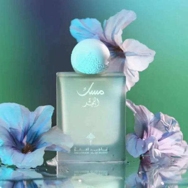 Musk Al Fajr by Ibraheem AlQuraishi 75ml Eau de Parfum displayed with purple flowers on a gradient background, highlighting its floral and fruity notes.