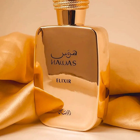 Hawas Elixir by Rasasi EDP 100ml in a luxurious gold bottle, displayed with golden satin fabric, ideal for Arabian perfume lovers.