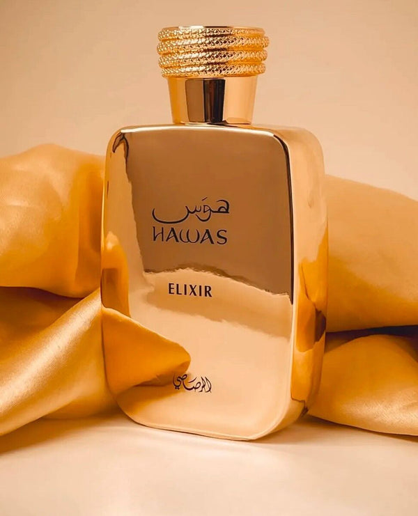 Hawas Elixir by Rasasi EDP 100ml in a luxurious gold bottle, displayed with golden satin fabric, ideal for Arabian perfume lovers.